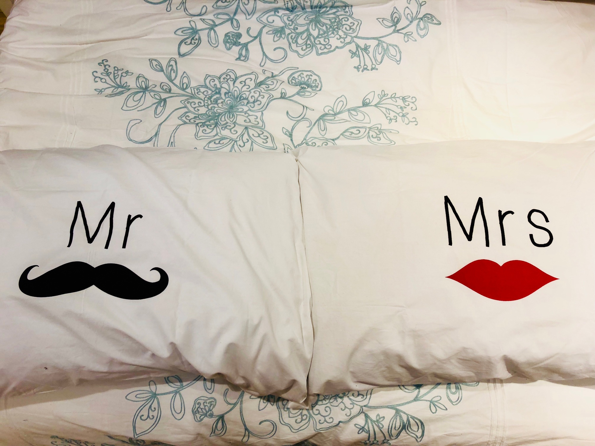 Personalized pillowcases on a bed.